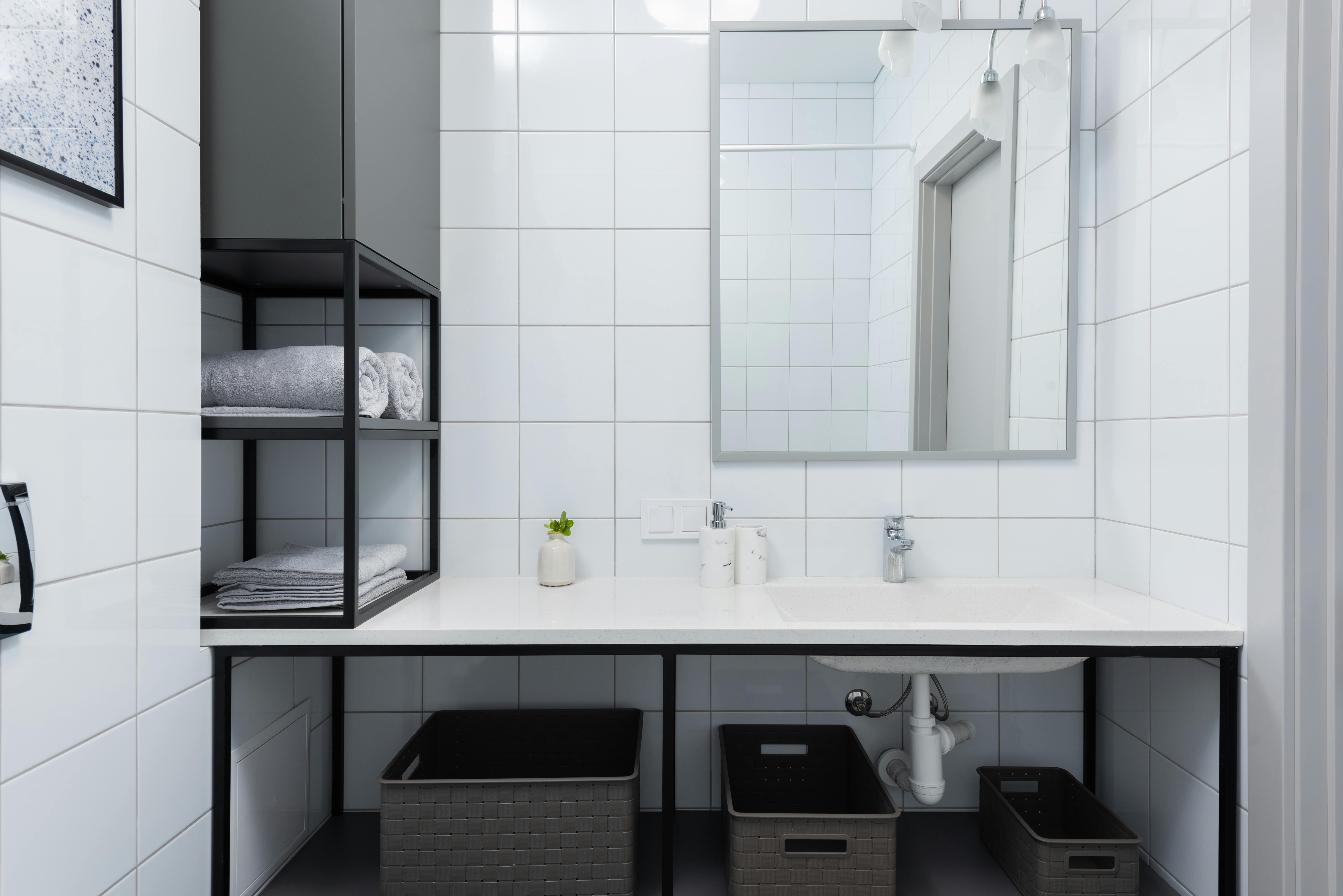 Modern bathroom renovation with white tiles and contemporary fixtures