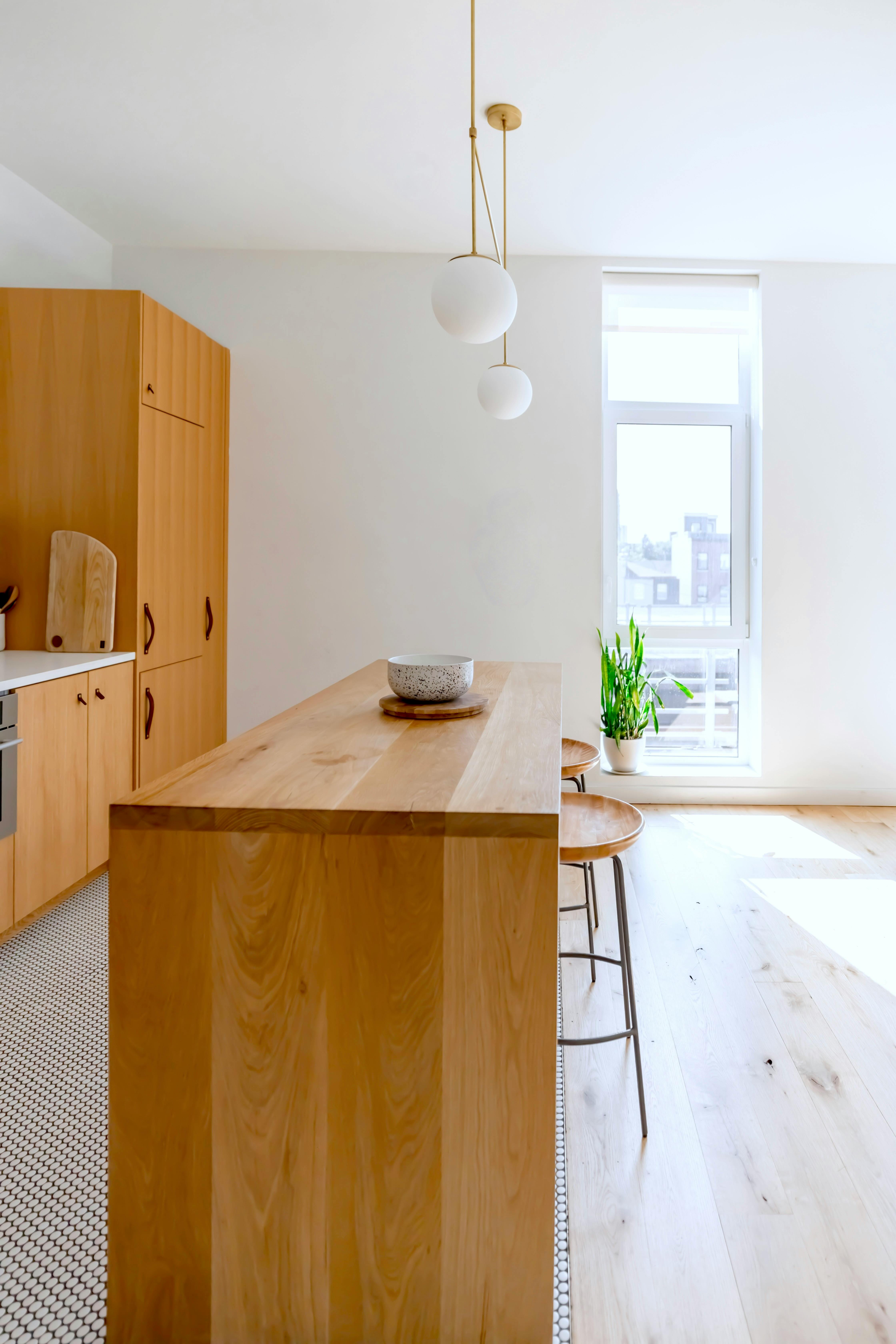 Modern completed kitchen renovation with wood cabinets and island