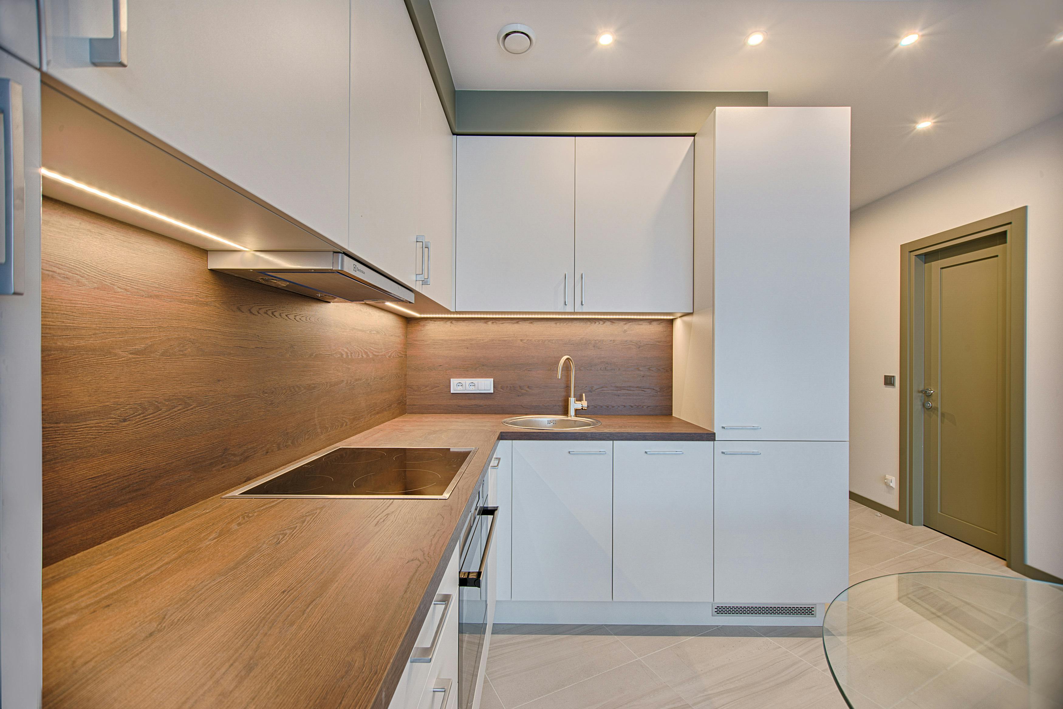 Modern renovated kitchen with white cabinets and wood countertops